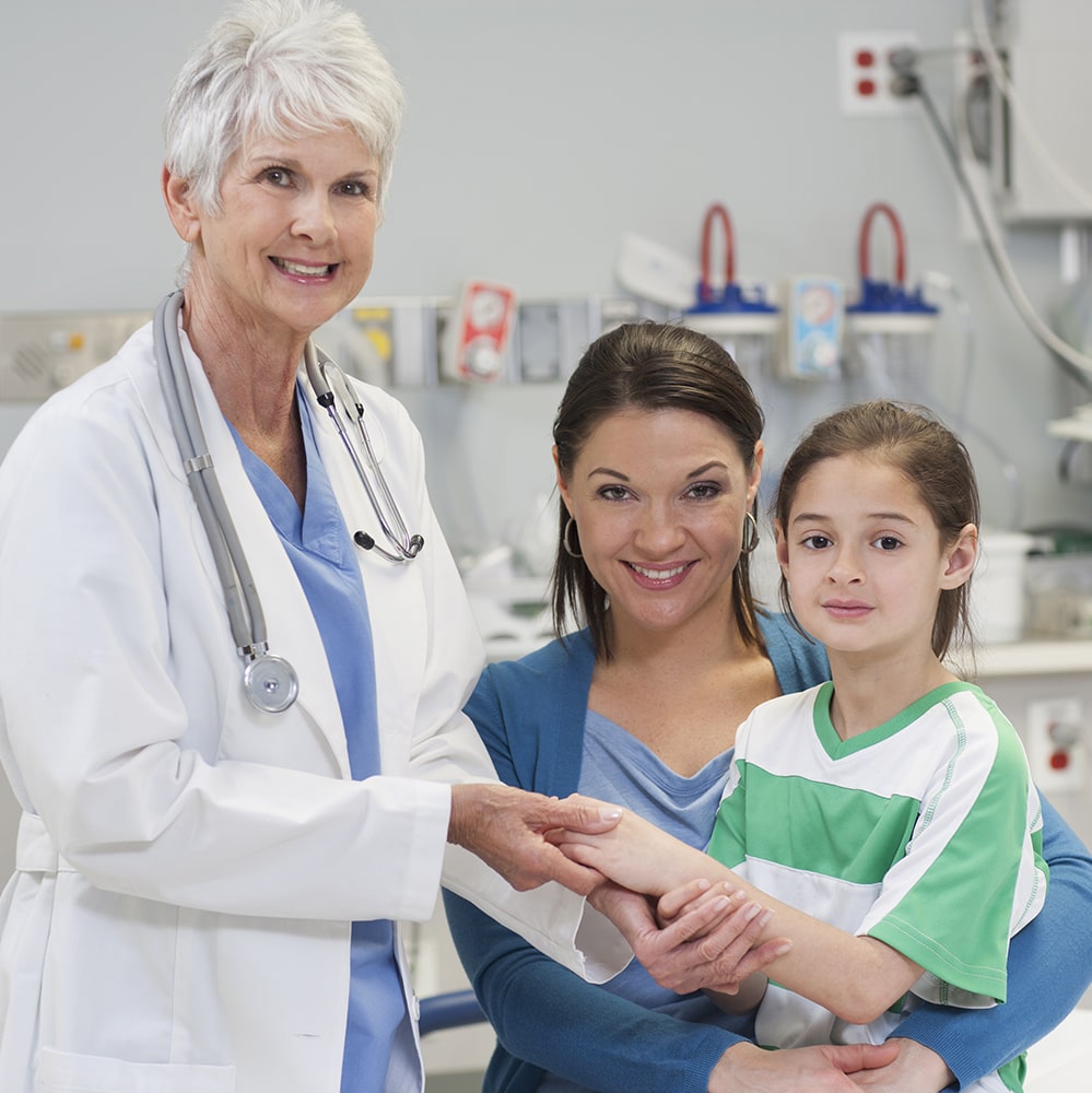 doctor with mother and daughter at healthcare facility